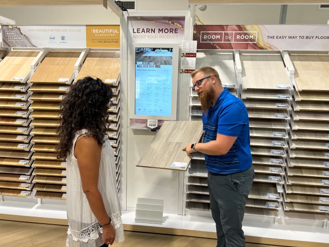 Parkland Carpet One sales team helping a customer choose a flooring sample